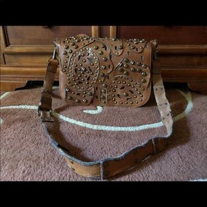 Brown distressed studded Patricia Nash bag.